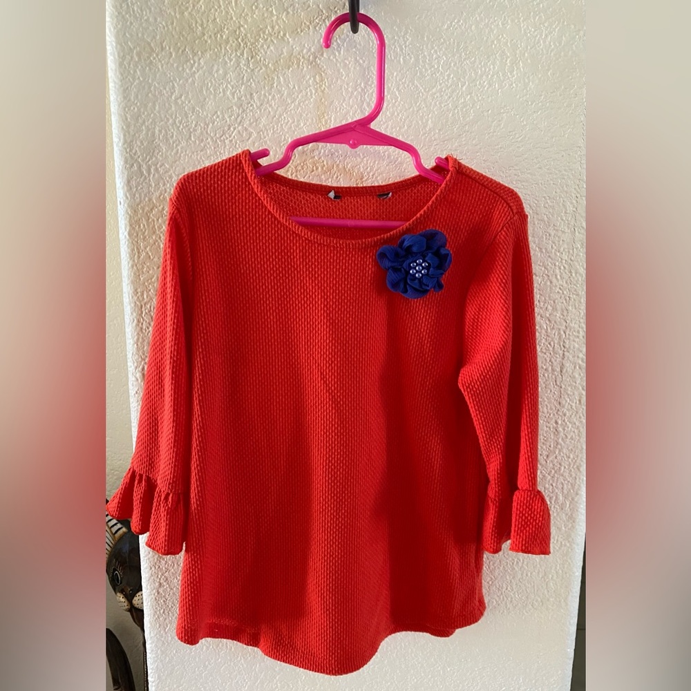 Young Girls cute top , Orange with a blue flower , Gently Used